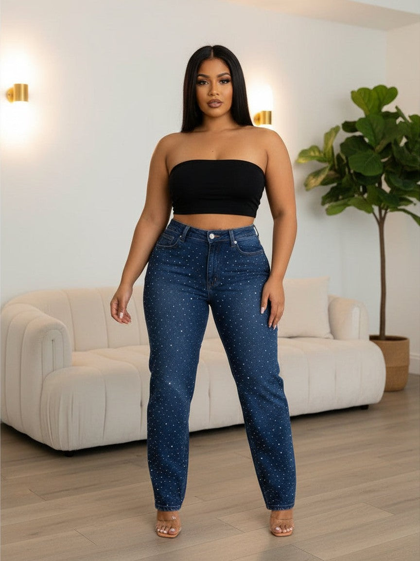 Woman wearing blue jeans with star patterns on a plain background