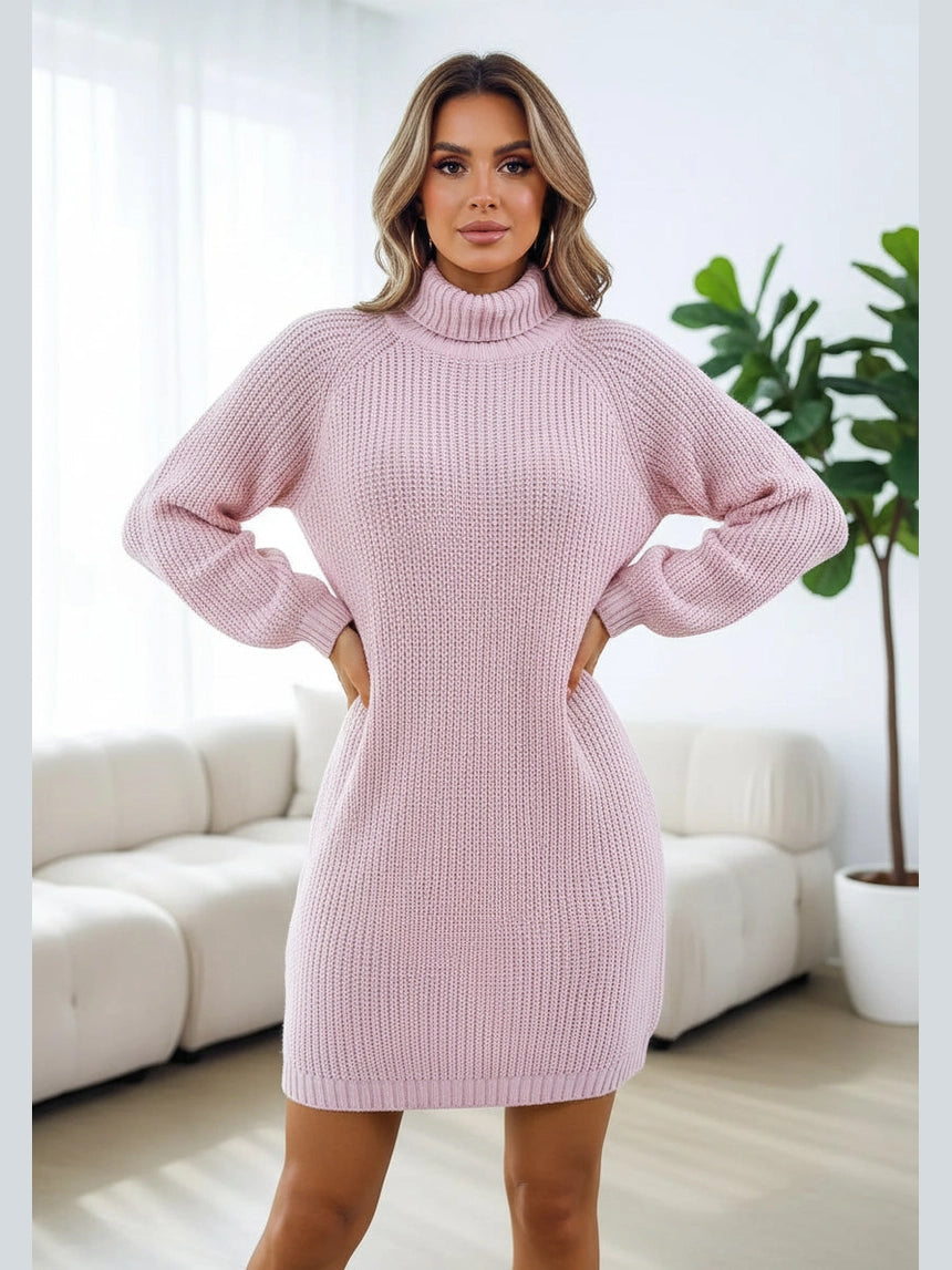 Pink knitted dress worn by a person against a white background