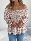 Off-shoulder floral blouse with a vibrant floral pattern, elastic neckline, and flowy sleeves, perfect for a feminine and effortless look in white standing up