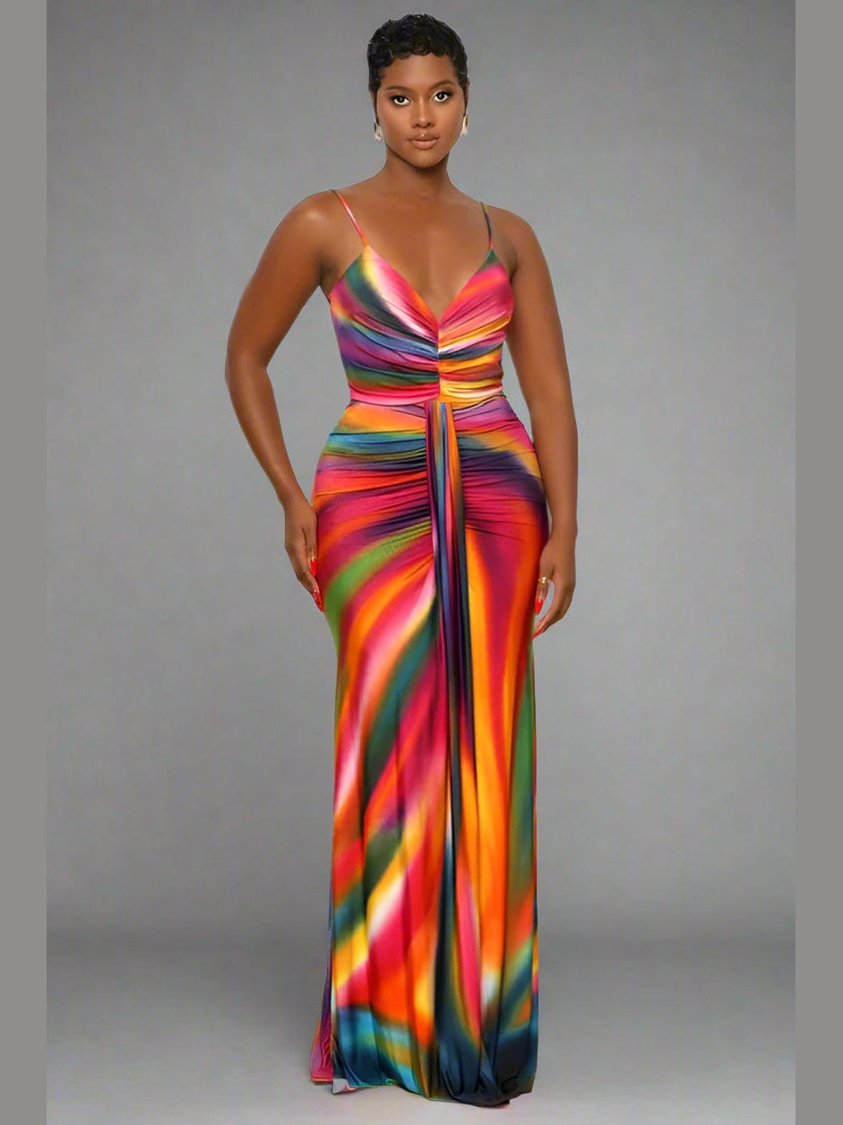 Model wearing a sleeveless multicolor maxi dress with thin straps, a V-neckline, and a flowy, draped skirt — perfect for summer or casual occasions