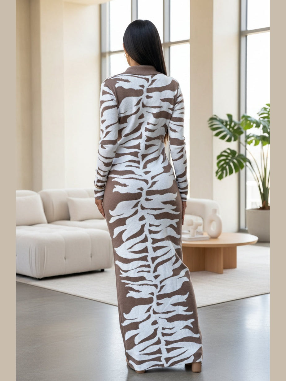 Woman wearing a long, patterned dress in a modern living room.