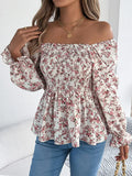 Off-shoulder floral blouse with a vibrant floral pattern, elastic neckline, and flowy sleeves, perfect for a feminine and effortless look in white. Model has hand on her shoulder