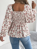 Off-shoulder floral blouse with a vibrant floral pattern, elastic neckline, and flowy sleeves, perfect for a feminine and effortless look in white facing backwards