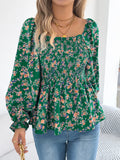 Off-shoulder floral blouse with a vibrant floral pattern, elastic neckline, and flowy sleeves, perfect for a feminine and effortless look facing forward in green
