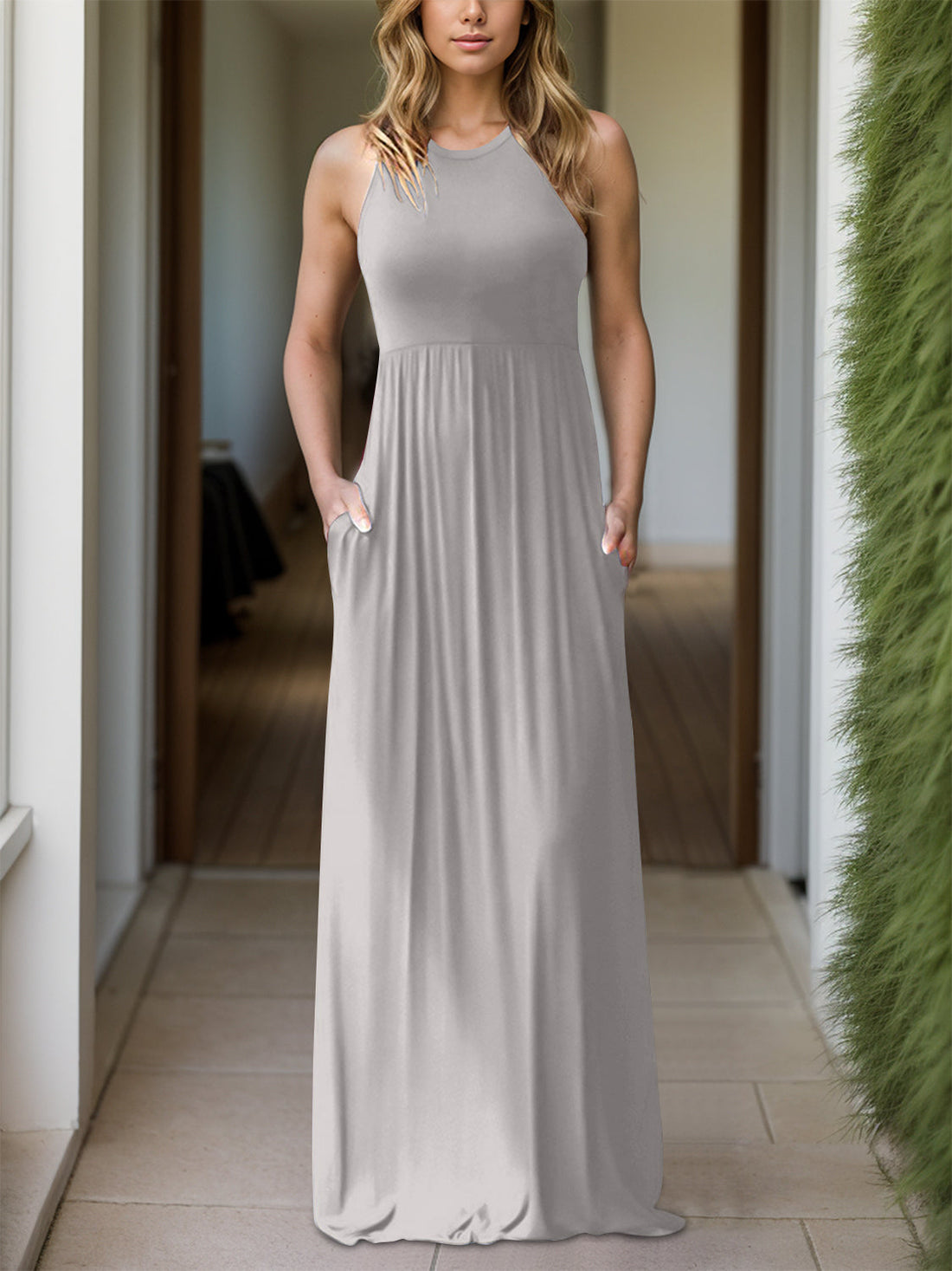 An elegant Grecian neck dress in deep navy, featuring a draped neckline and practical pockets, ideal for both formal occasions and everyday comfort