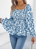 Off-shoulder floral blouse with a vibrant floral pattern, elastic neckline, and flowy sleeves, perfect for a feminine and effortless look in blue. 