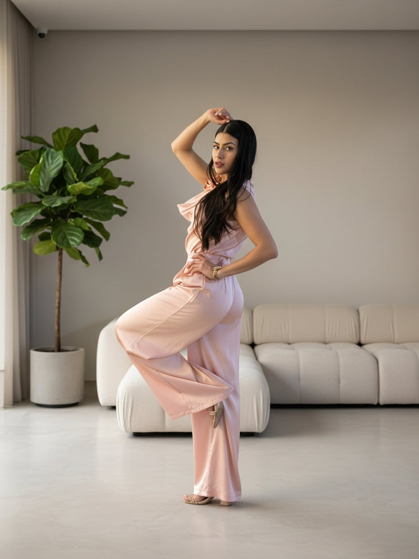 Woman in a pink dress posing outdoors at night.