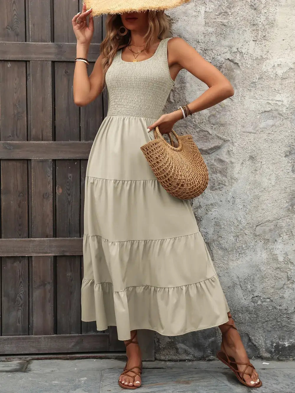 Model posing in the Ivy Lane Sleeveless Tank Dress with one hand on her hip, holding a purse, showcasing a chic and casual summer look in ivory color dress