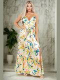 Model wearing the Star Gazing Maxi Dress in Yellow, emphasizing the playful cut-off front side and flowing design
